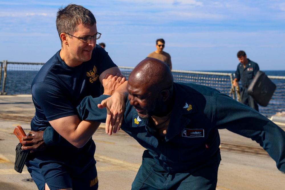 FCC Ian Beckwith and GM1 Don Dume demonstrate an effective arm-grab and take-down maneuver