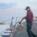 BM3 Jonathon Reynolds heaves in a mooring line from a tug boat during sea-and-anchor detail