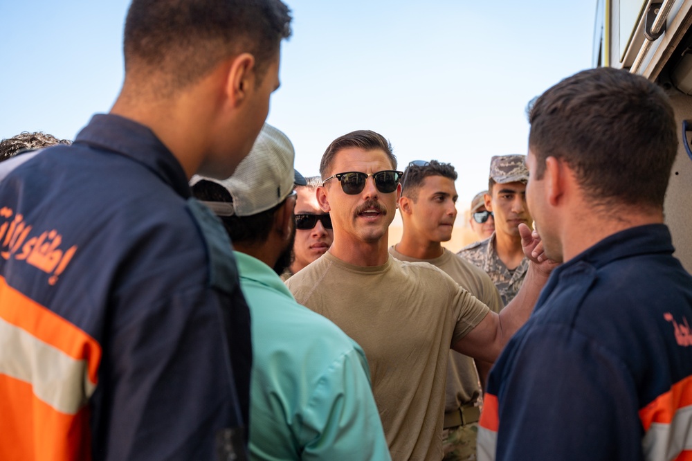 USAF and partner nation service members participate in a joint fire vehicle inspection