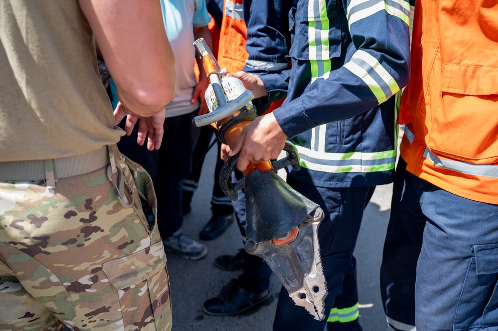 USAF and partner nation service members participate in a joint fire vehicle inspection