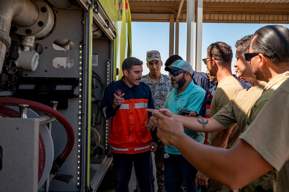 USAF and partner nation service members participate in a joint fire vehicle inspection