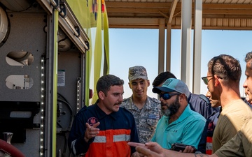 USAF and partner nation service members participate in a joint fire vehicle inspection