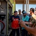 USAF and partner nation service members participate in a joint fire vehicle inspection