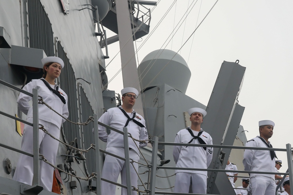 Sailors aboard the USS John Finn man the rails during a sea and anchor detail in Jakarta, Indonesia