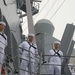 Sailors aboard the USS John Finn man the rails during a sea and anchor detail in Jakarta, Indonesia