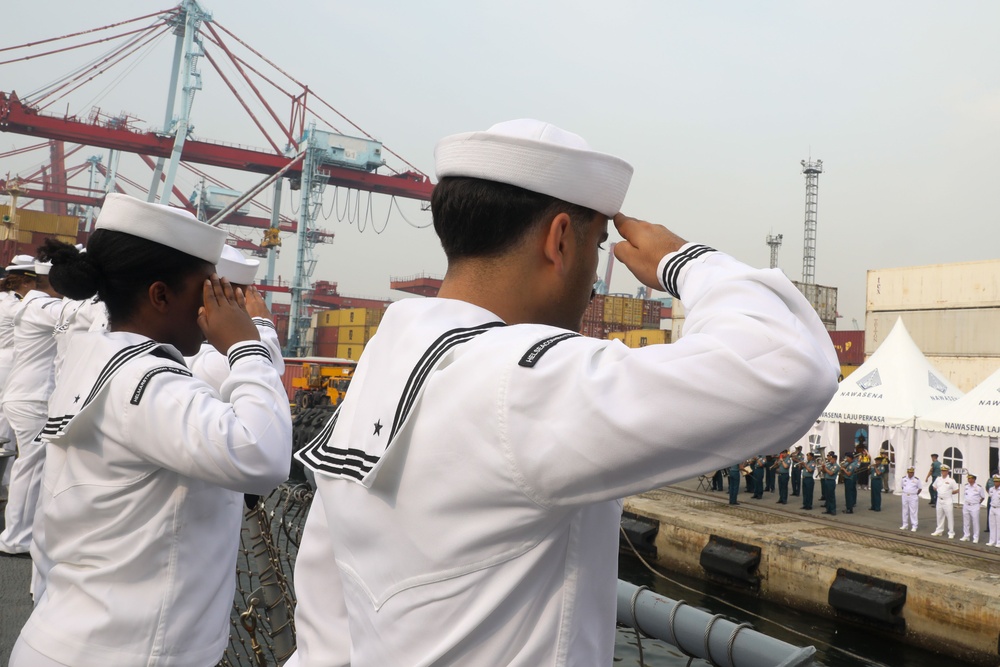 Sailors aboard the USS John Finn man the rails during a sea and anchor detail in Jakarta, Indonesia