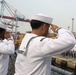 Sailors aboard the USS John Finn man the rails during a sea and anchor detail in Jakarta, Indonesia