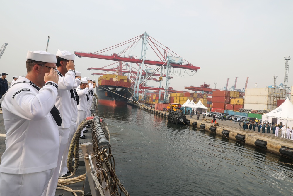 Sailors aboard the USS John Finn man the rails during a sea and anchor detail in Jakarta, Indonesia