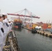 Sailors aboard the USS John Finn man the rails during a sea and anchor detail in Jakarta, Indonesia