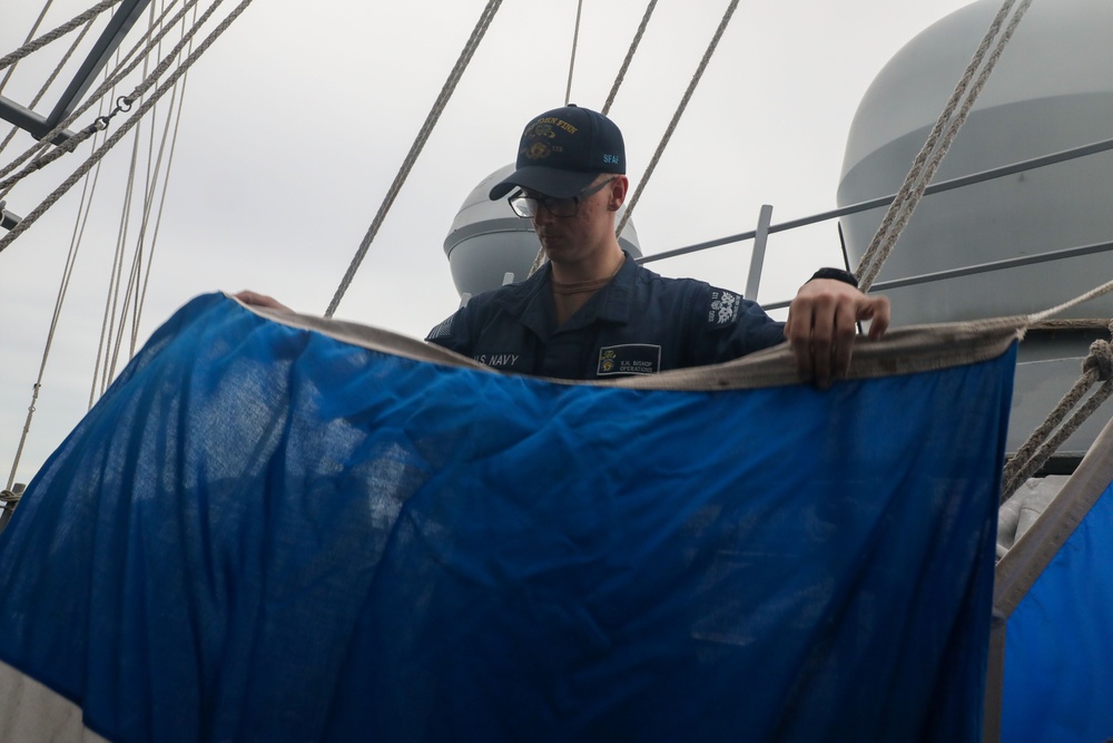 Sailors aboard the USS John Finn conduct a visual communication exercise during Super Garuda Shield in the Java Sea
