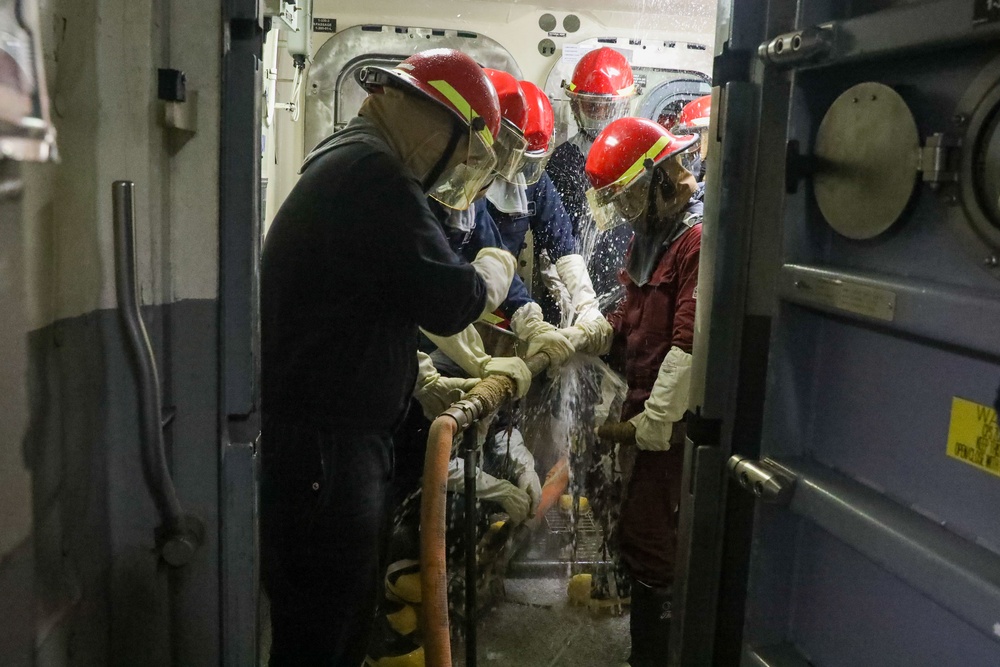 Sailors aboard the USS John Finn conduct a damage control exercise in the Java Sea
