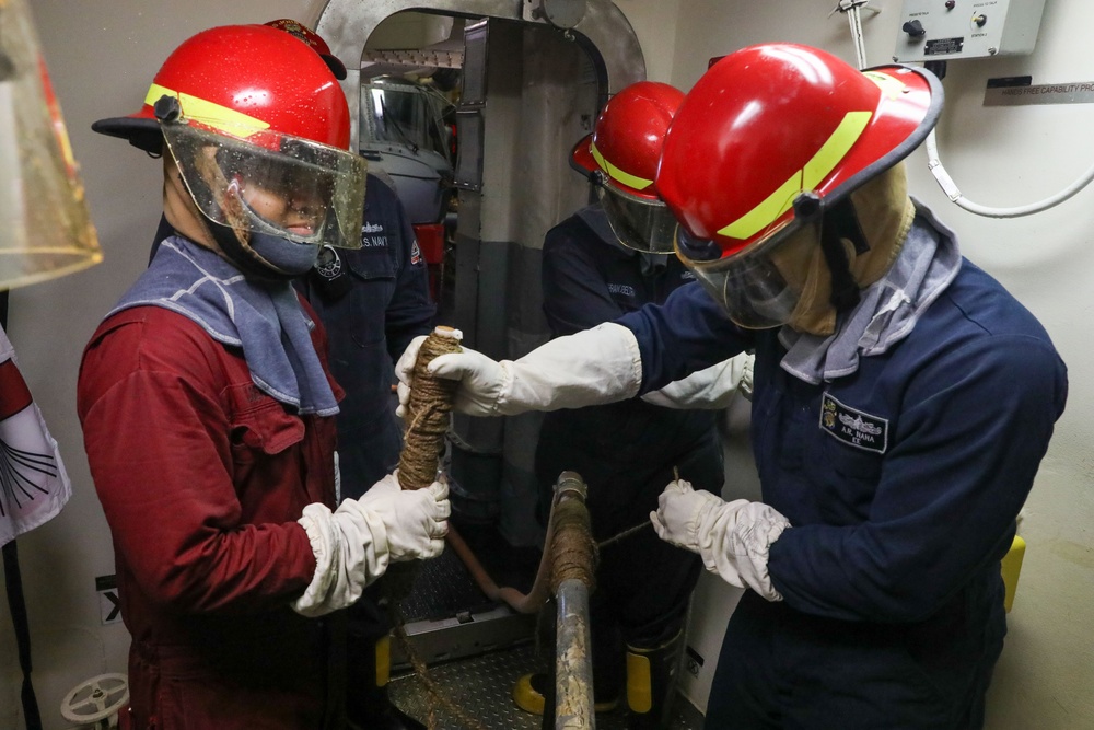 Sailors aboard the USS John Finn conduct a damage control exercise in the Java Sea