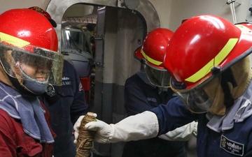 Sailors aboard the USS John Finn conduct a damage control exercise in the Java Sea
