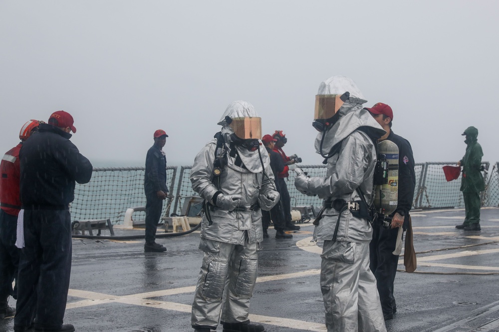 Sailors aboard the USS John Finn conduct a crash and salvage drill in the Java Sea