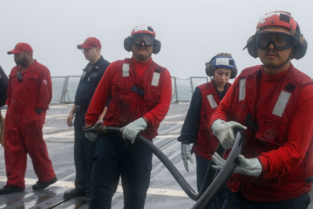 Sailors aboard the USS John Finn conduct a crash and salvage drill in the Java Sea