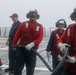 Sailors aboard the USS John Finn conduct a crash and salvage drill in the Java Sea