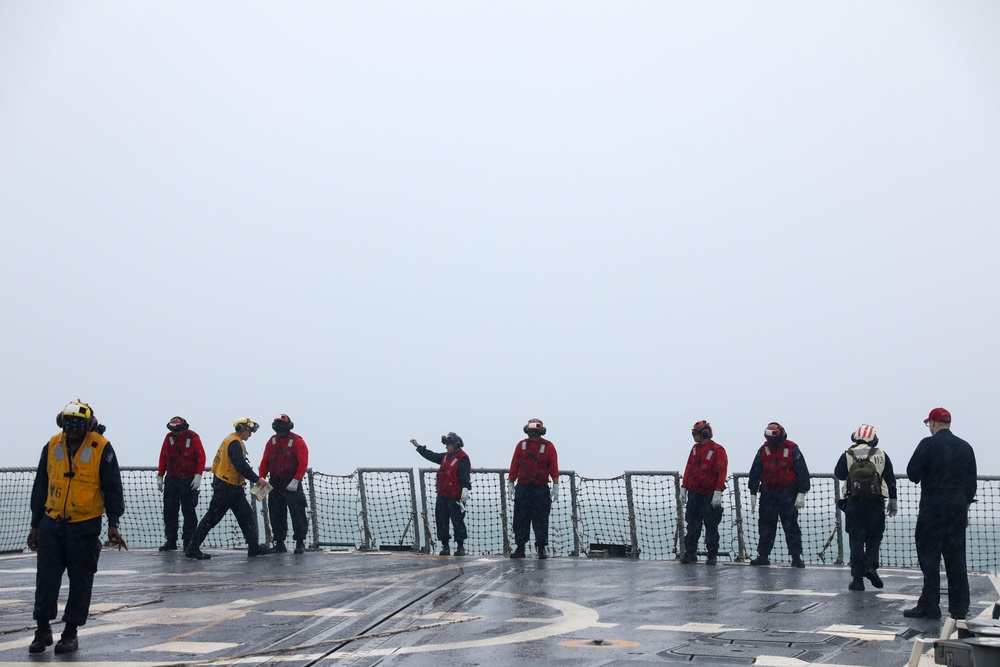 Sailors aboard the USS John Finn conduct a crash and salvage drill in the Java Sea