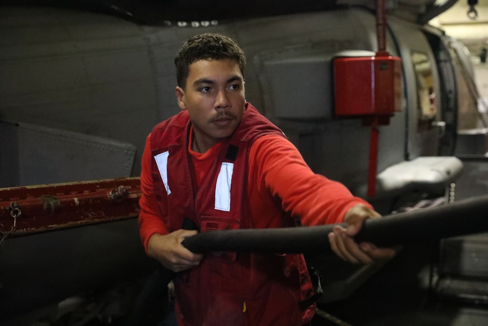 Sailors aboard the USS John Finn conduct a crash and salvage drill in the Java Sea