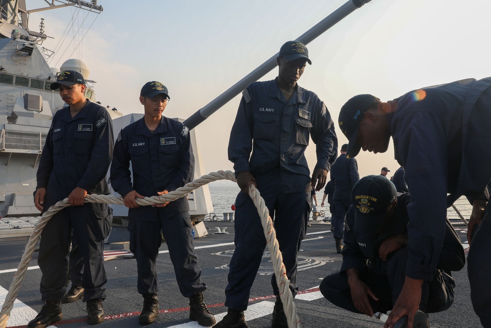 Sailors aboard the USS John Finn conduct a sea and anchor detail in Jakarta, Indonesia