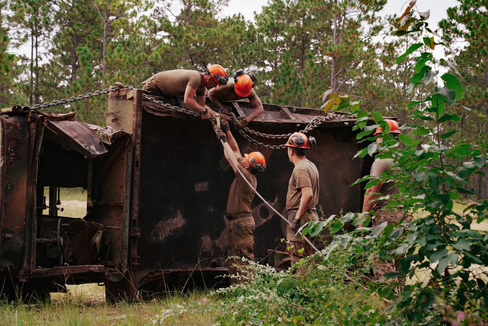 U.S. Army Soldiers rig an overturned vehicle during the Wheeled Vehicle Recovery Operations Course held at the 139th Regional Training Institute in Fort Bragg, NC, August 8, 2025.
