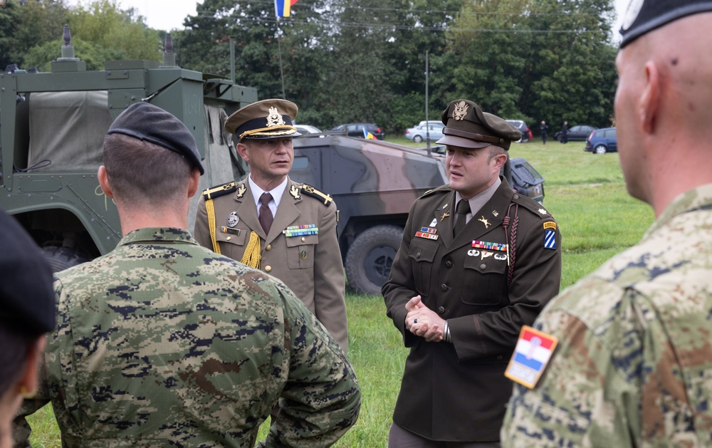 U.S. Army and Romanian leaders discuss static display with Croatian soldiers