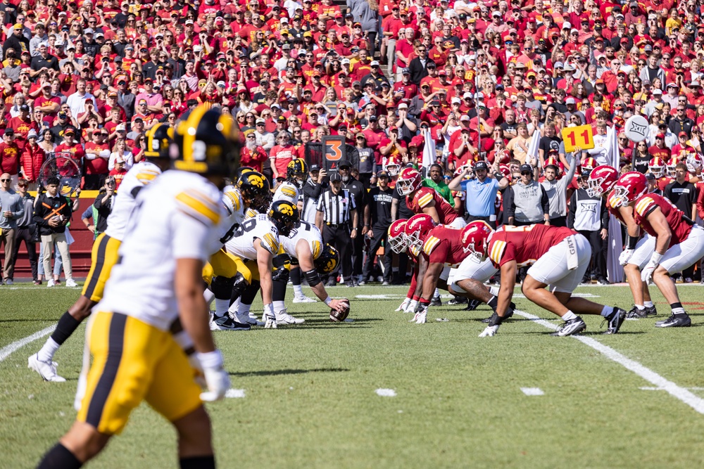 Iowa and Iowa State players lined up to hike ball at Cy-Hawk game