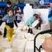 Children imitating construction workers and build model buildings at STEM event