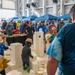 Children portray construction workers and build model buildings at STEM exhibit