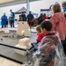 Children control robotic balls from digital tablets during a STEM exhibit