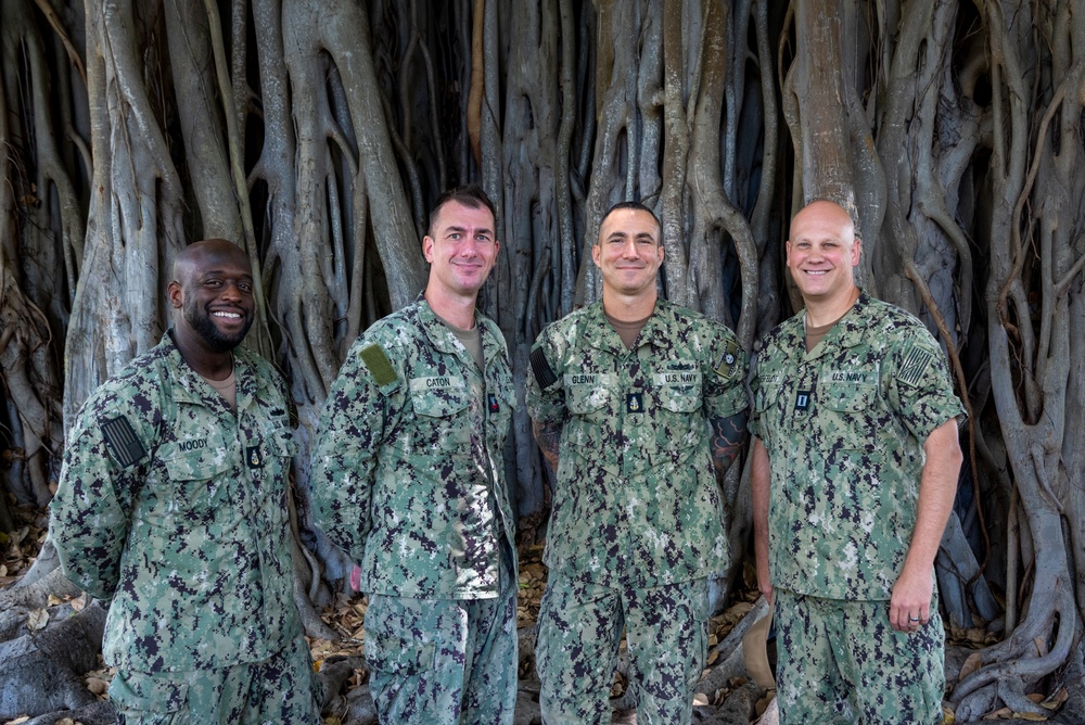 MU2 Caton Poses for a Photo with Band Leadership following Reenlistment