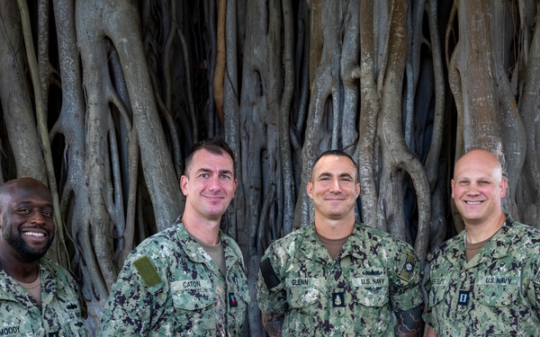 MU2 Caton Poses for a Photo with Band Leadership following Reenlistment