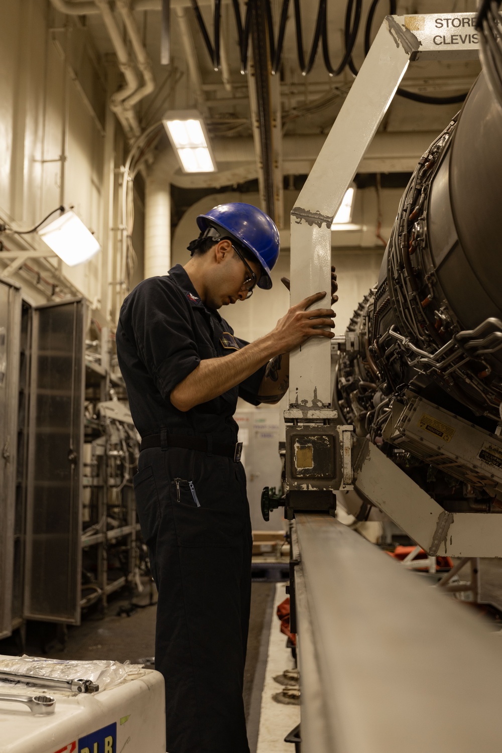USS Gerald R. Ford (CVN 78) Sailor Conducts Maintenance on a Jet Engine