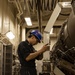 USS Gerald R. Ford (CVN 78) Sailor Conducts Maintenance on a Jet Engine