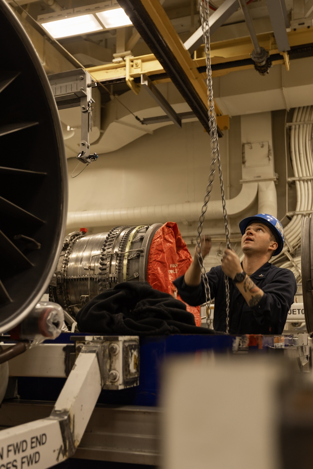USS Gerald R. Ford (CVN 78) Sailor Conducts Maintenance on a Jet Engine