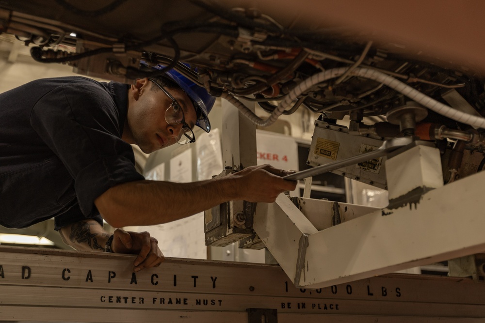 USS Gerald R. Ford (CVN 78) Sailor Conducts Maintenance on Jet Engine