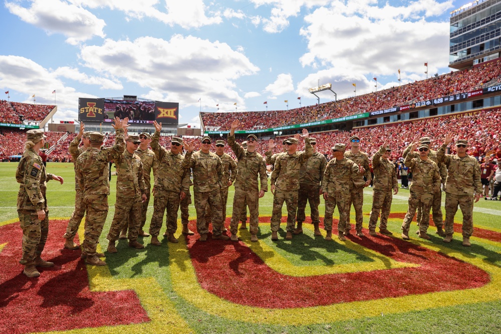 Iowa Army National Guard air crew waves at fans in Jack Trice Stadium