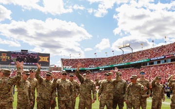 Iowa Army National Guard air crew waves at fans in Jack Trice Stadium