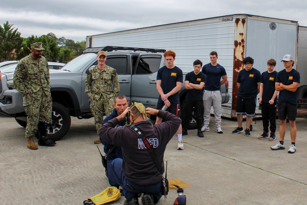 Fire Department Demonstrates Donning Fire Fighting Equipment