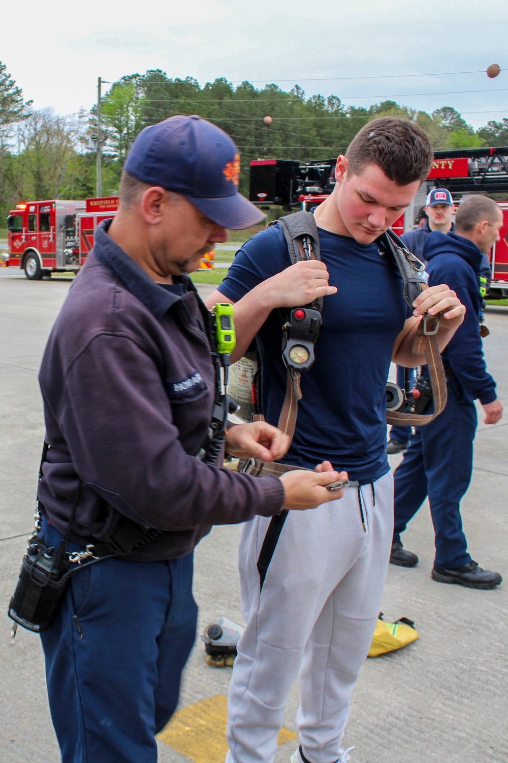 Fire Department Demonstrates Donning Fire Fighting Equipment