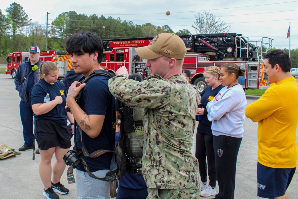 Navy Recruiter Assists Delayed Entry Member With Donning Fire Fighting Gear