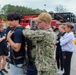 Navy Recruiter Assists Delayed Entry Member With Donning Fire Fighting Gear