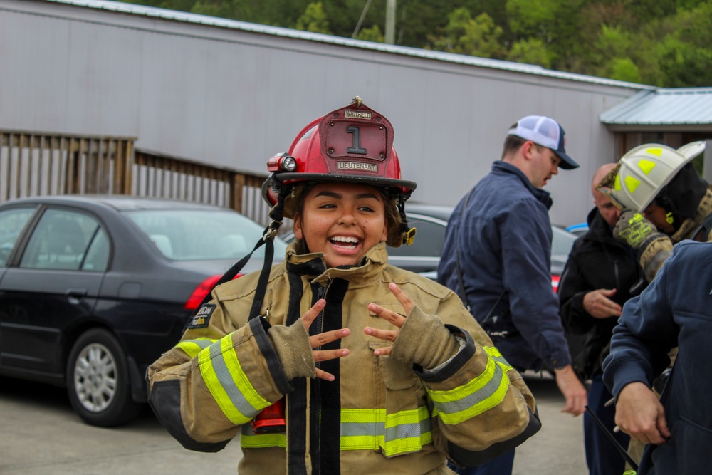 Delayed Entry Member Donning Fire Fighting Gear