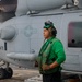 AD2 Keith Gonzales stands ready to support the launch of an MH-60R Sea Hawk helicopter