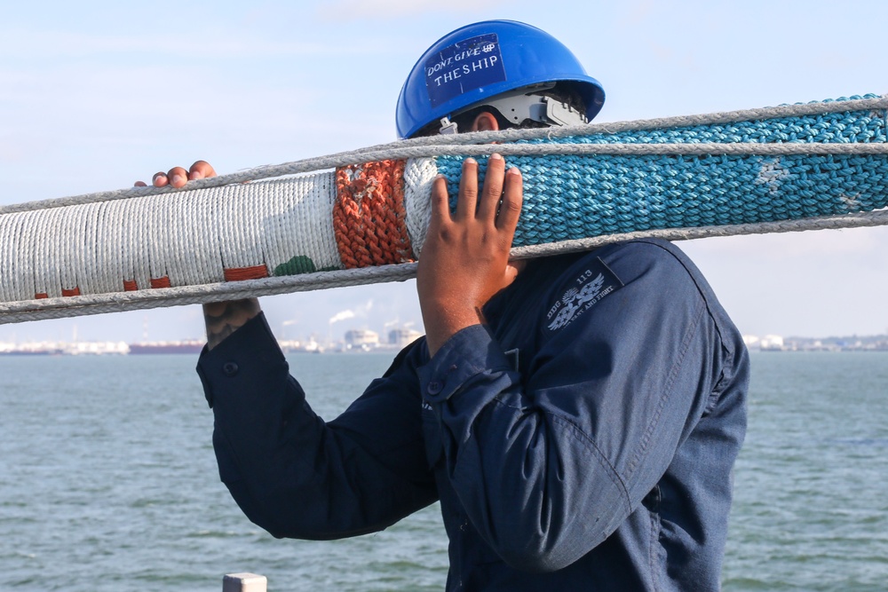 Sailors aboard the USS John Finn conduct a sea and anchor detail In Changi, Singapore