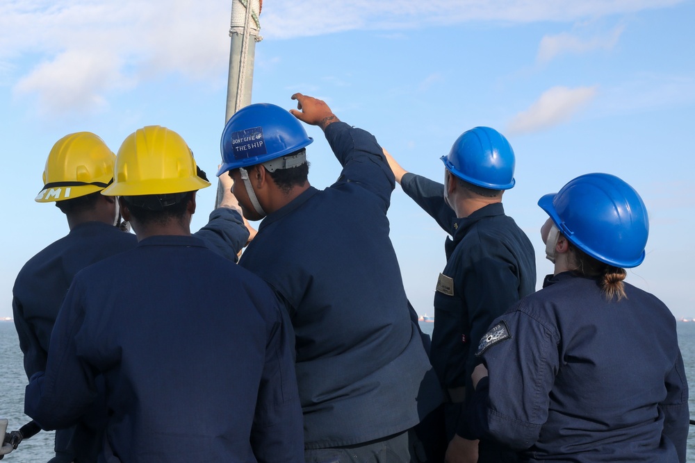 Sailors aboard the USS John Finn conduct a sea and anchor detail In Changi, Singapore