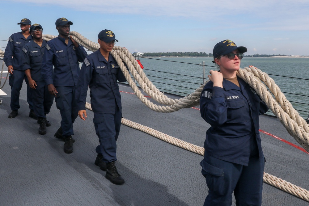 Sailors aboard the USS John Finn conduct a sea and anchor detail In Changi, Singapore