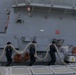 Sailors aboard the USS John Finn conduct a sea and anchor detail In Changi, Singapore