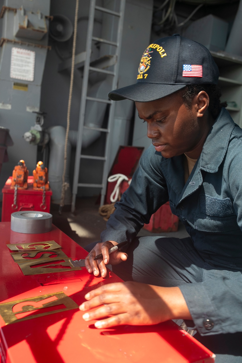 USS Tripoli Sailors Preform Maintenance