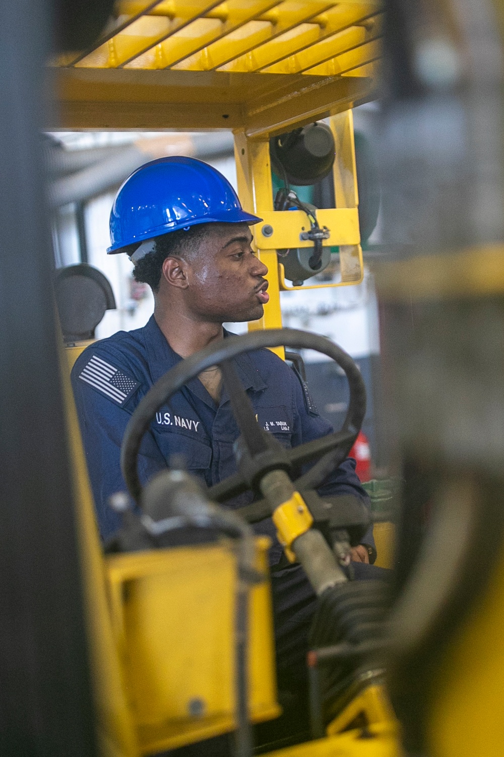 USS Tripoli Sailors Preform Maintenance