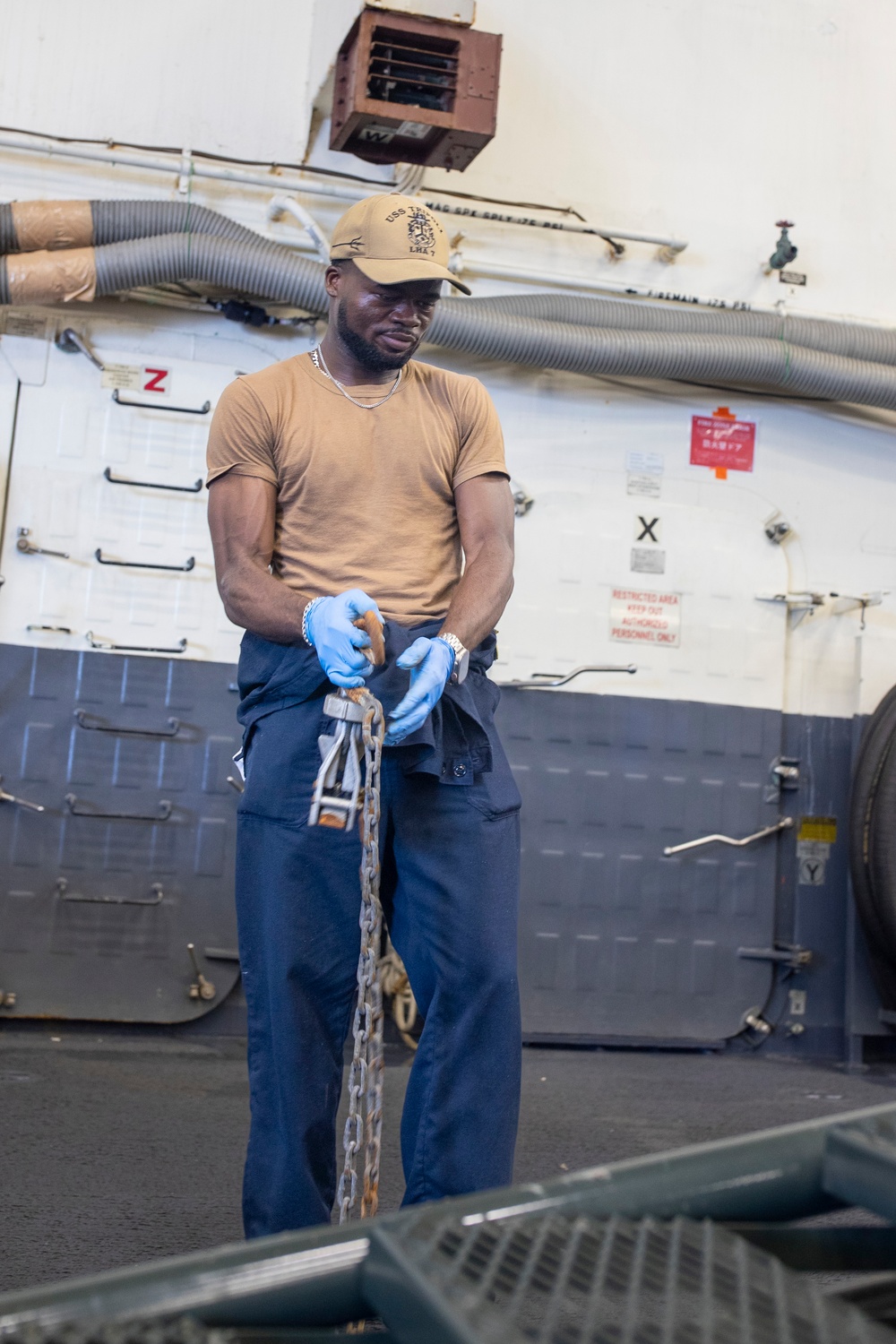 USS Tripoli Sailors Preform Maintenance